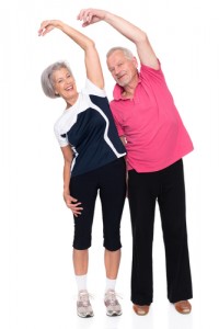 Active senior couple in front of white background